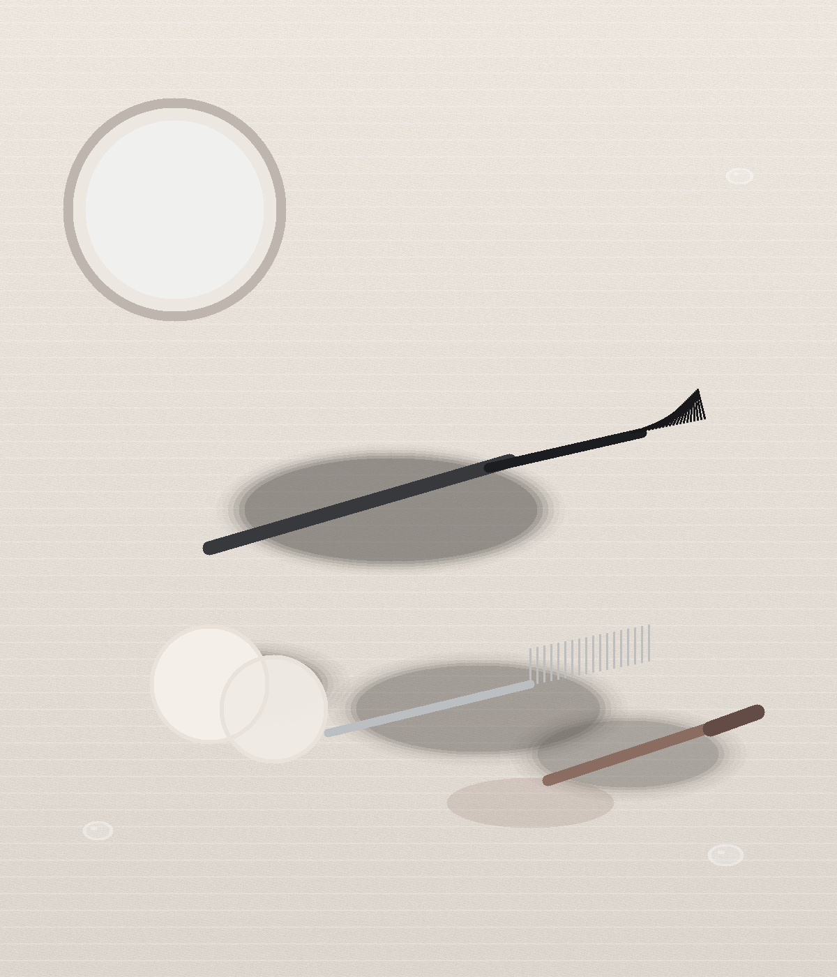 Still life of a mascara wand, a silver lash comb, two cotton pads, and a brown eye pencil on cream linen, with a round mirror cropped into the upper corner.