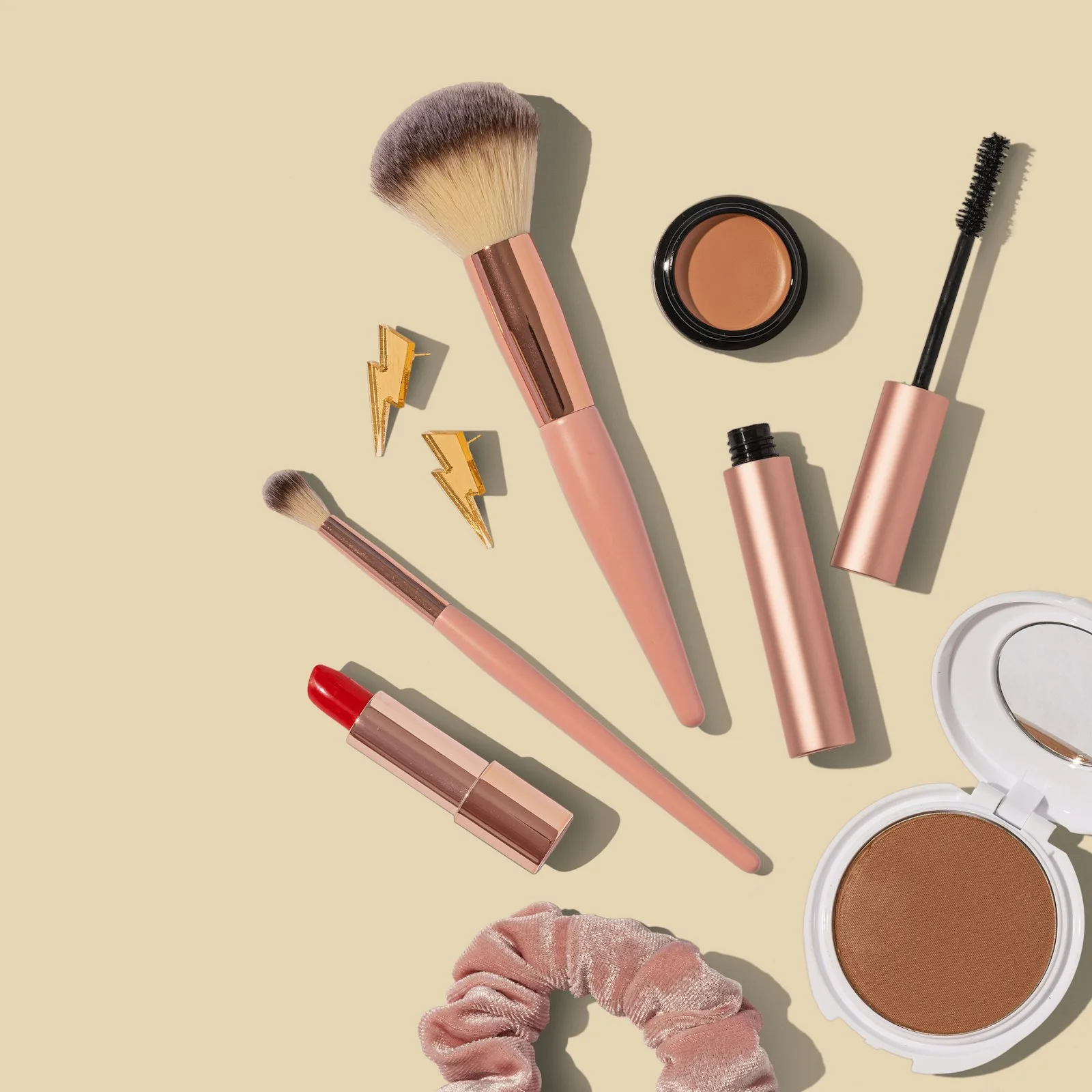 Beauty products arranged on a pink surface