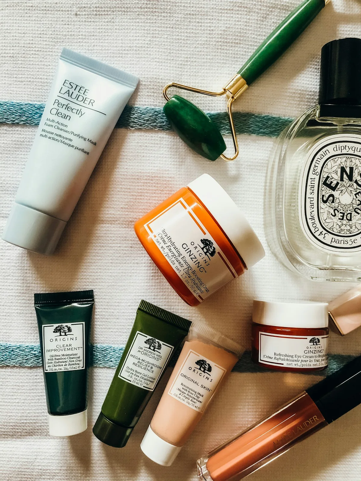 Cream, cleanser, and skincare tools arranged on a counter