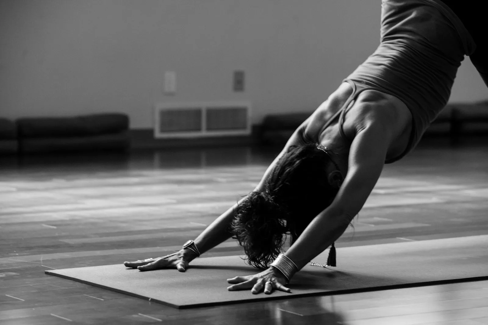 Person stretching on a yoga mat in a bright studio